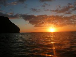 Sunset from the deck of Crazy Love at anchor in Nualolo.