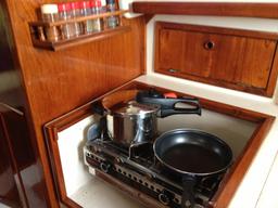 Stove uncovered. It acts as our chart table as well with a nestled in counter.